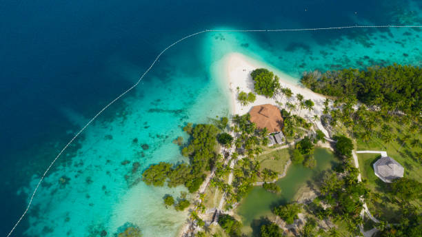 Tropical island with beach. Malipano island, Philippines, Samal. stock photo