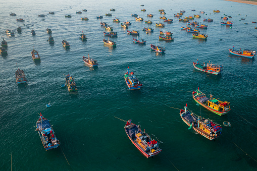 Drone view of fishing boats are nailing side by side on Xuan Hai beach, Song Cau town, Phu Yen province, central Vietnam