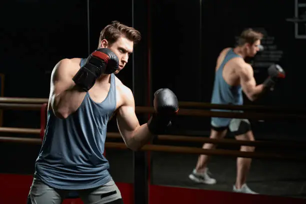 Photo of Concentrated professional male athlete training at gym