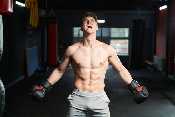 istock Young energetic boxer screaming during gym workout 1402899216