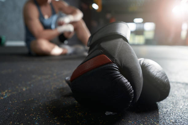istock Protective boxing gear and athlete resting after workout 1402899286