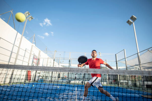 Man playing paddle tennis in court , ready for smash in sports class stock photo