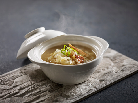 Dried Fish Maw and Crab Meat Thick Soup served in a pot isolated on mat side view on grey background