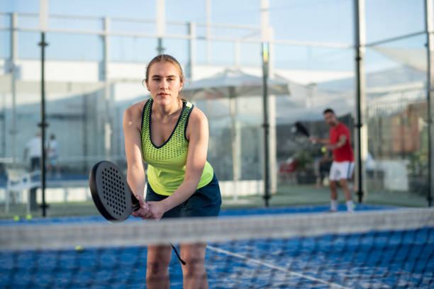 istock Couple playing paddle tennis in court 1402900007