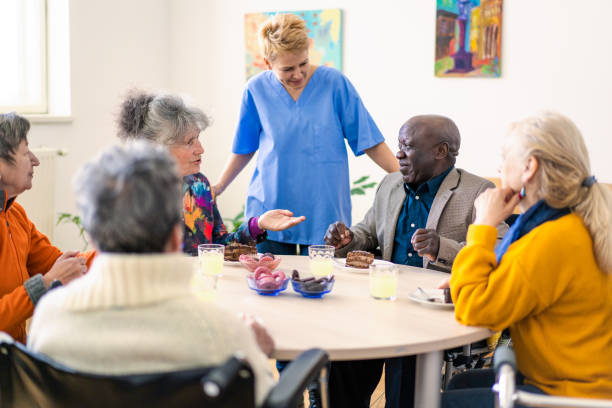 istock A female medical orderly working with senior citizens 1402900200