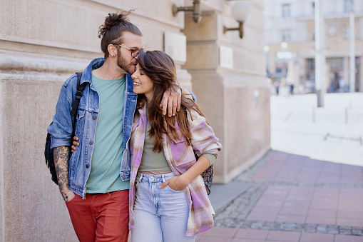 Young hipster couple walking in the city street