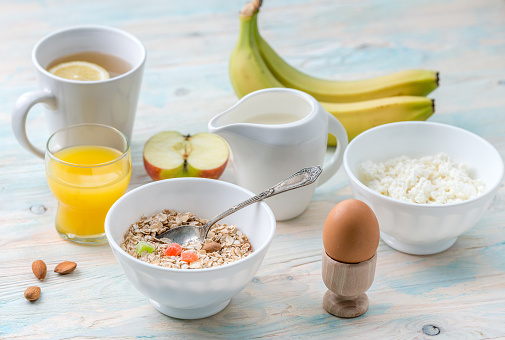 Yummy healthy and nutritious brunch with cottage cheese and eggs, oats and fruits, aromatic tea