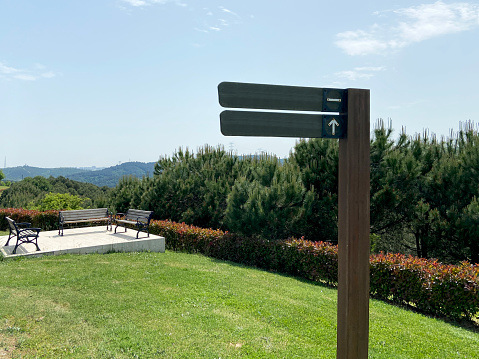 Signpost on trail in front of blue sky