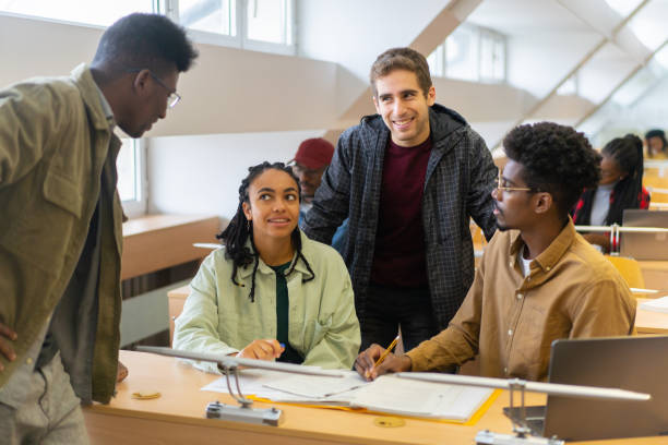 istock Foreign students chatting together in a lecture hall 1402904283