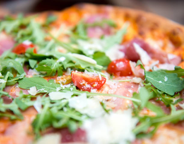 istock Pizza with dry cured ham and arugula close-up 1402905221