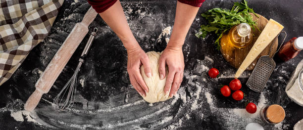 istock Woman kneading dough for pizza baking 1402905245