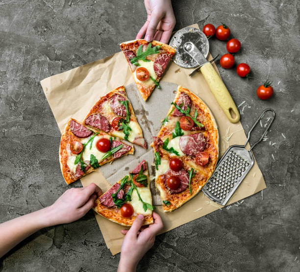 istock children's hands take homemade pizza with salami 1402905275