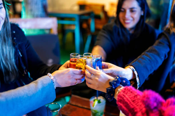 istock women toasting in a pub or restaurant celebrating happily, hand view 1402906361