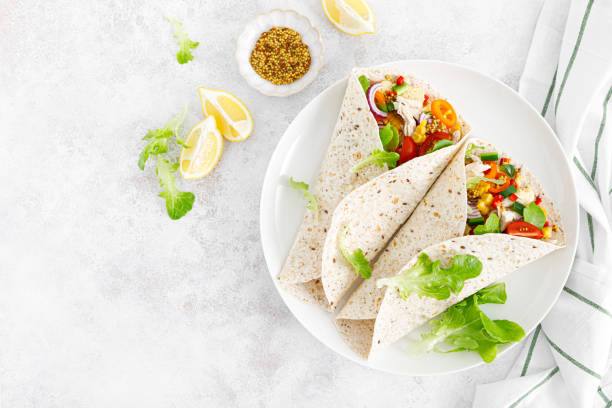 istock Mexican tacos with chicken meat and vegetables. Top view 1402906535