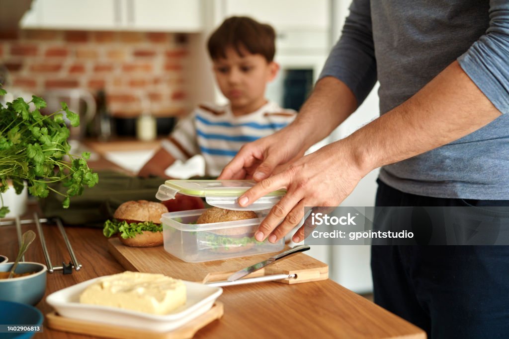 Midsection Of Man Preparing Food On Table  Lunch Box Stock Photo
