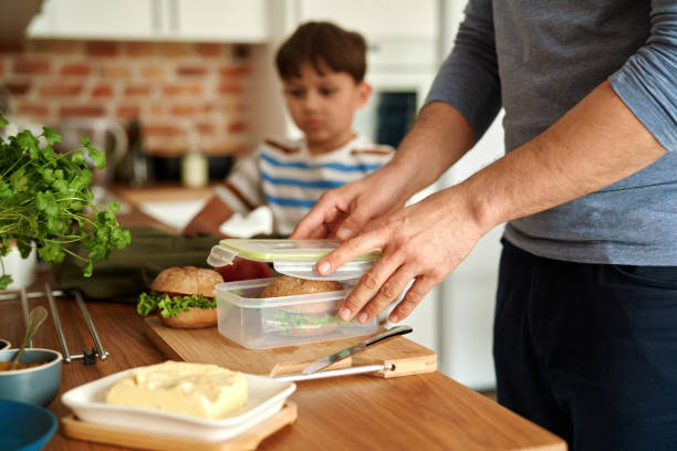 midsection of man preparing food on table - child human hand sandwich lunch box imagens e fotografias de stock