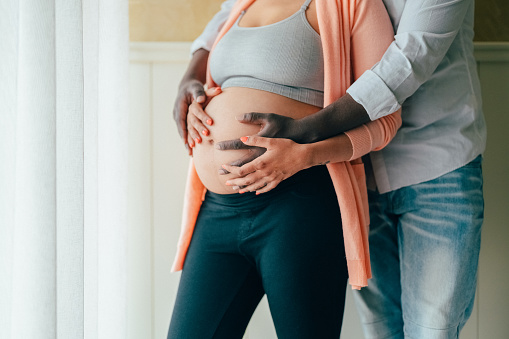 Man touching the belly of his pregnant wife