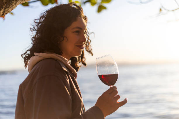 istock Latin woman drinking wine at sunset 1402909819