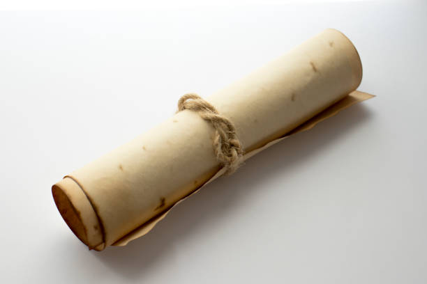 istock Antique paper scroll, insulated on white background laid at an oblique angle. 1402909850