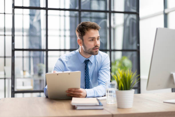 istock Successful entrepreneur is studying documents with attentive and concentrated look. 1402910342