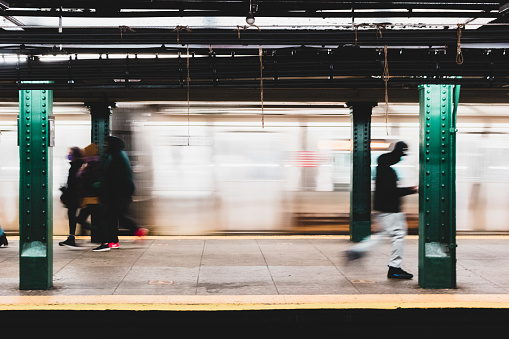 Defocused, motion blurred train platform during morning commute