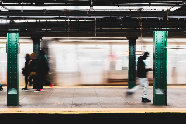 Busy transit station in New York City Defocused, motion blurred train platform during morning commute train stations stock pictures, royalty-free photos & images