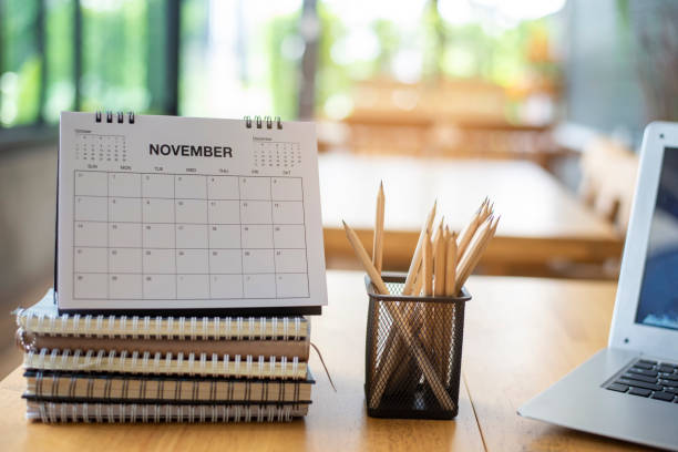 istock Desk for student education concept. Calendar, Laptop, Pencils, book, note pad placed on School table for student work online at home. 1402912767