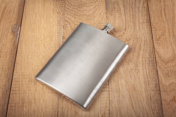 istock Stainless hip flask on wooden background 1402912777