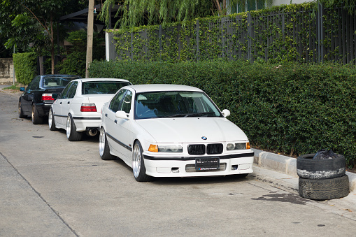 Three BMW M2 and M3 sports cars parked in street in Bangkok