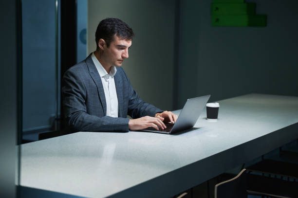 istock Concentrated office employee typing on laptop at long table 1402914446