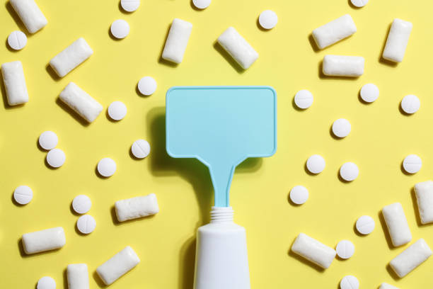 istock Titanium dioxide, E171, dangerous additive concept. gum, pills, toothpaste or cream and sign with space on yellow background. copy space 1402916380
