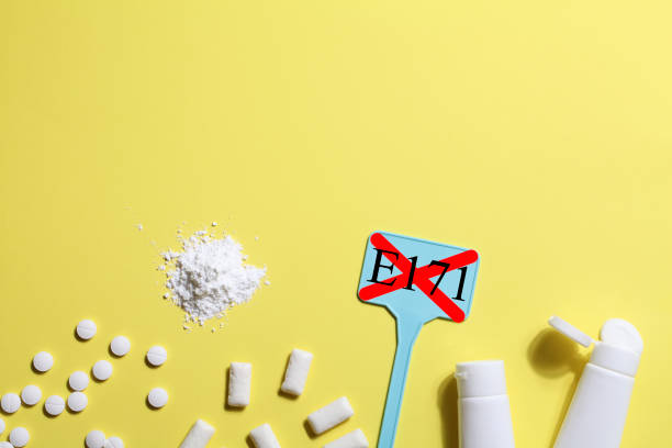 istock Titanium dioxide, E171, dangerous additive concept. gum, pills, toothpaste, powder and sign with E171 on yellow background. copy space 1402916438