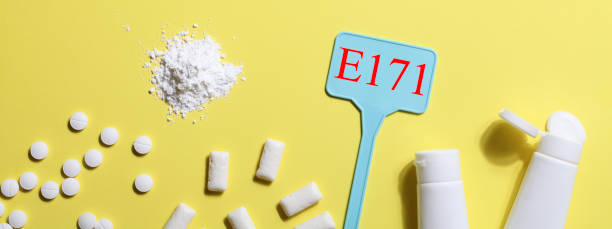 Titanium dioxide, E171, dangerous additive concept. gum, pills, toothpaste, powder and sign with E171 on yellow background. copy space banner