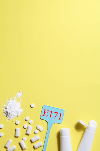 istock Titanium dioxide, E171, dangerous additive concept. gum, pills, toothpaste, powder and sign with E171 on yellow background. copy space 1402916475