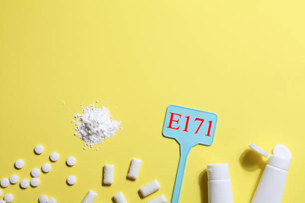 istock Titanium dioxide, E171, dangerous additive concept. gum, pills, toothpaste, powder and sign with E171 on yellow background. copy space 1402916476