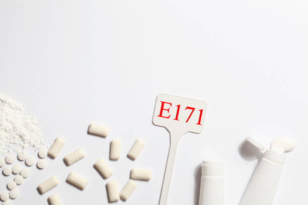 istock Titanium dioxide, E171, dangerous additive concept. gum, pills, toothpaste, powder and sign with E171 on white background. copy space 1402916496