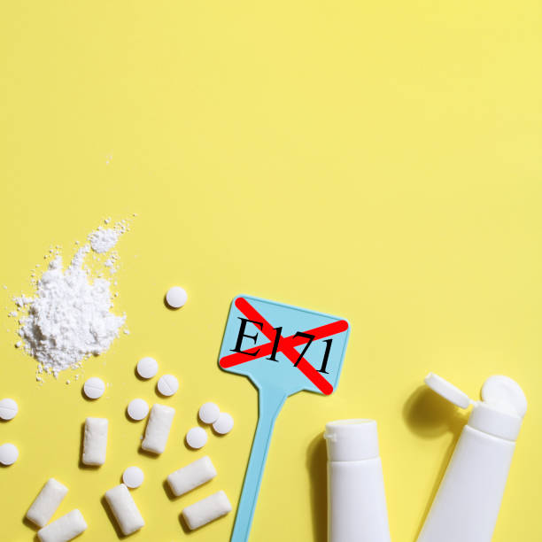 istock Titanium dioxide, E171, dangerous additive concept. gum, pills, toothpaste, powder and sign with E171 on yellow background. copy space square 1402916500