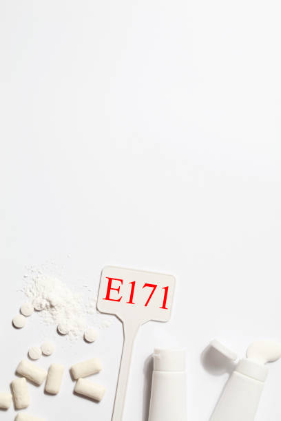 istock Titanium dioxide, E171, dangerous additive concept. gum, pills, toothpaste, powder and sign with E171 on white background. copy space 1402916557