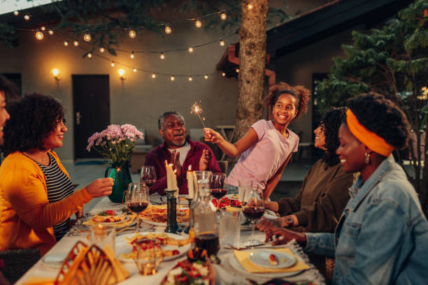 istock African family gathering in the backyard, having dinner 1402916850