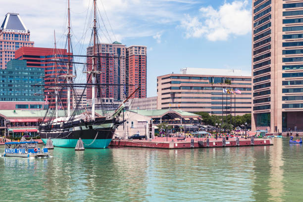 The Baltimore ,Maryland skyline frames the Baltimore Inner Harbor and all of its tourist attractions stock photo