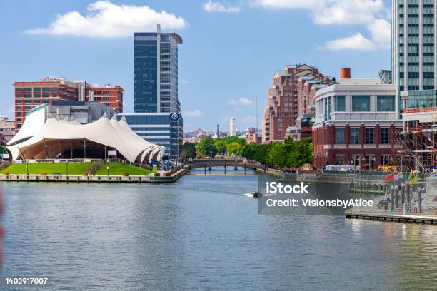 Pier Six Concert Pavilion Alongside The Treelined Jones Falls Channel At Baltimore Inner Harbor With Museums And Other Attractions Plus Residential Structures On The Other Side Of The Canal Stock Photo - Download Image Now