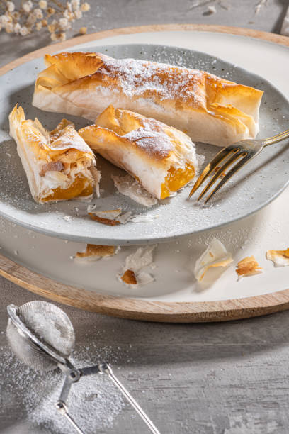 istock Typical portuguese sweets Pasteis de Vouzela served on countertop. Filo pastry with egg cream filling 1402918523