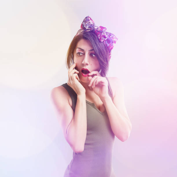 Attractive young woman shocked while talking on the phone