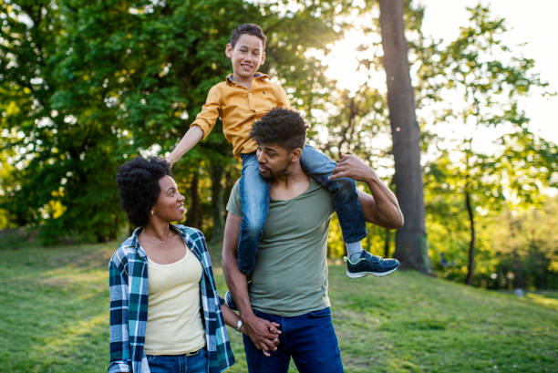 istock Young loving family having fun in the park 1402919788