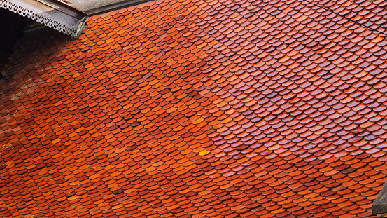 Roof tiles of old traditional thai wooden building in Bangkok Chatuchak