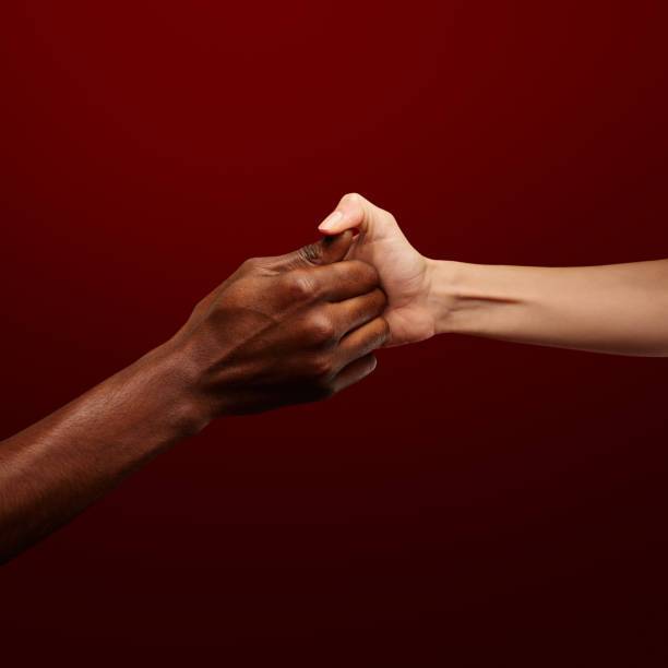 istock Two hands gripping for each other and play thumb wrestling. Human relations, power, unity, togetherness, symbolism concept 1402921870