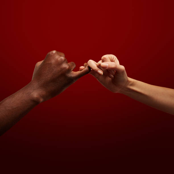 istock Two hands gripping each other with pinky finger. Pinky promise. Human relations, power, unity, togetherness, symbolism concept 1402922191