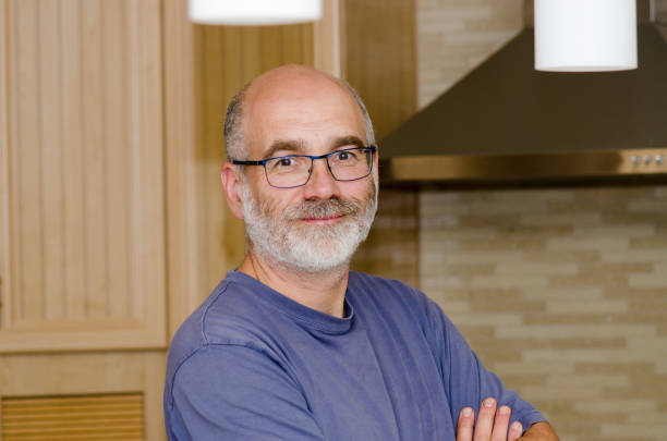 istock Headshot of mature man in kitchen 1402927139
