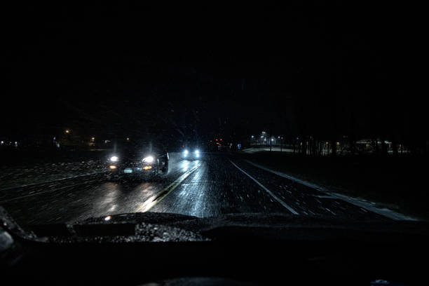 istock Approaching Cars Passing On Dark Rural Highway 1402929543