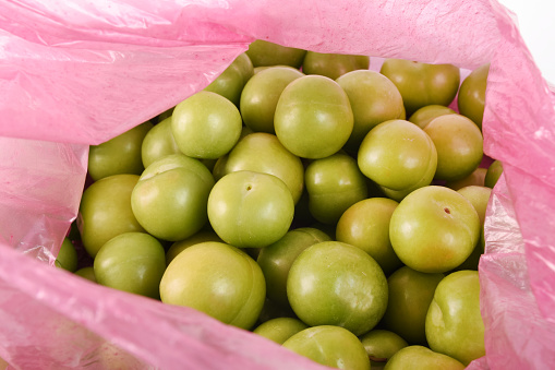 Fresh green plums in the plastic bag
